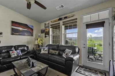 a living room with a leather couch and a table at Aspen Meadows F-304, 0014 in Granby