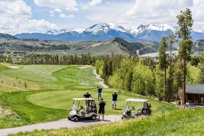 a group of people playing golf on a golf course at Beautiful Renovated 1BR Lakeside Condo condo in Keystone