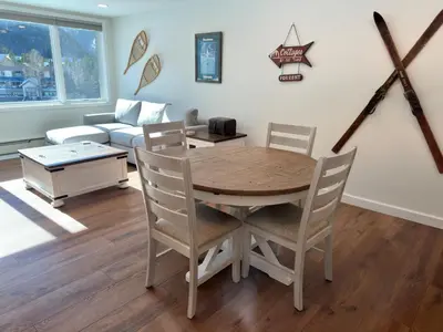 a living room with a table and chairs and a couch at Beautiful Renovated 1BR Lakeside Condo condo in Keystone