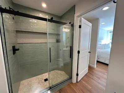 a bathroom with a shower with a glass door at Beautiful Renovated 1BR Lakeside Condo condo in Keystone