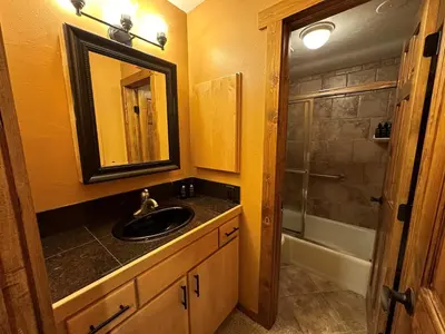 a bathroom with a sink and a shower at Lakeside, spacious, modern 2BR - sleeps up to 8 condo in Keystone