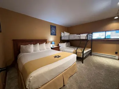 a hotel room with two beds and a bunk bed at Lakeside, spacious, modern 2BR - sleeps up to 8 condo in Keystone
