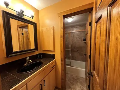 a bathroom with a sink and a shower at Lakeside, spacious, modern 2BR - sleeps up to 8 condo in Keystone