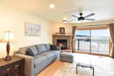 a living room with a couch and a fireplace at Lake Forest Mountainview Condo: Great Location, Amazing Views in Frisco