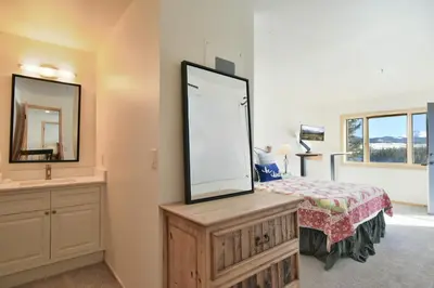 a bedroom with a large mirror and a bed at Lake Forest Mountainview Condo: Great Location, Amazing Views in Frisco