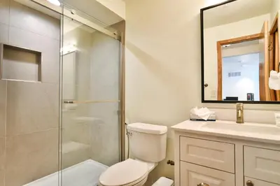 a bathroom with a shower and a toilet and a sink at Lake Forest Mountainview Condo: Great Location, Amazing Views in Frisco