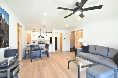 a living room with a couch and a ceiling fan at Lake Forest Mountainview Condo: Great Location, Amazing Views in Frisco