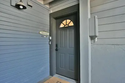 a door to a house with a sign on it at Lake Forest Mountainview Condo: Great Location, Amazing Views in Frisco