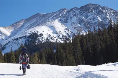 a person walking on a snow covered mountain at Lake Forest Mountainview Condo: Great Location, Amazing Views in Frisco