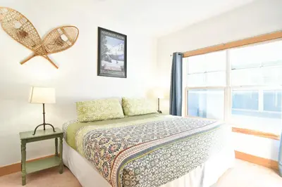 a bedroom with a bed and a window at La Riva Del Lago Condo: Downtown, Close to Everything in Dillon