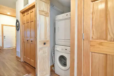 a laundry room with a washing machine and a washer at La Riva Del Lago Condo: Downtown, Close to Everything in Dillon