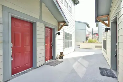 two red doors on the side of a house at La Riva Del Lago Condo: Downtown, Close to Everything in Dillon