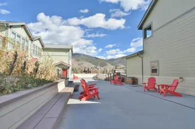 a group of red chairs sitting outside of a building at La Riva Del Lago Condo: Downtown, Close to Everything in Dillon