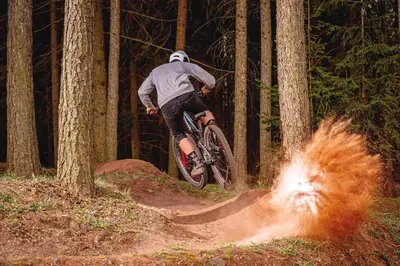 a man riding a dirt bike in the woods at Woodbridge Inn Getaway: Pet Friendly, Mountain Views in Frisco