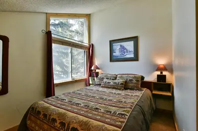 a bedroom with a bed and a window at Flying Dutchman Mountainside Condo: Pool/Hot Tub in Keystone