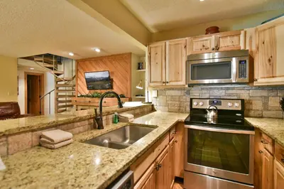 a kitchen with a sink and a microwave at Flying Dutchman Mountainside Condo: Pool/Hot Tub in Keystone