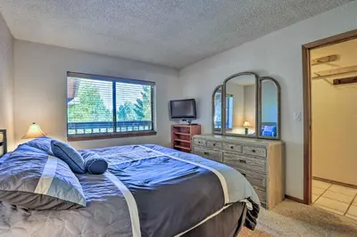 a bedroom with a bed and a tv and a mirror at Mountainside Royalview Condo: Pool/Hot Tubs, Great Location in Frisco