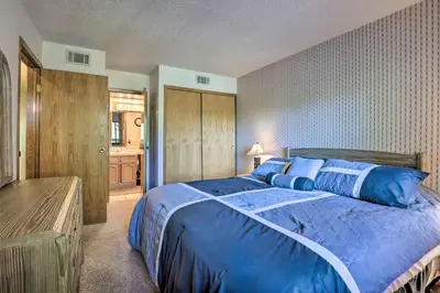 a bedroom with a blue bed and a bathroom at Mountainside Royalview Condo: Pool/Hot Tubs, Great Location in Frisco
