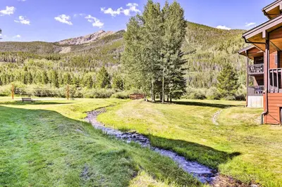 a stream in a field next to a house at Mountainside Royalview Condo: Pool/Hot Tubs, Great Location in Frisco