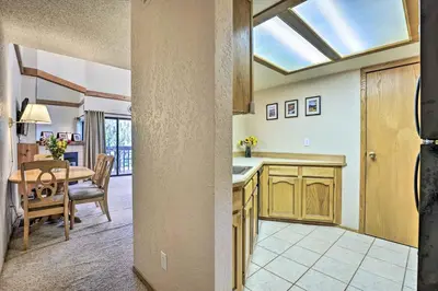 a kitchen and dining room with a table and a window at Mountainside Royalview Condo: Pool/Hot Tubs, Great Location in Frisco
