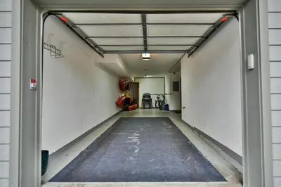 an empty garage with the door open to a room at Prospect Point Retreat: Lakeside Townhome, Mountain Views in Frisco