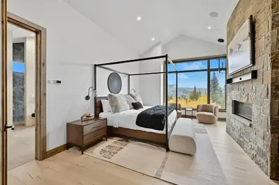 a bedroom with a bed and a fireplace at Brand New Eagles Nest Property in Silverthorne