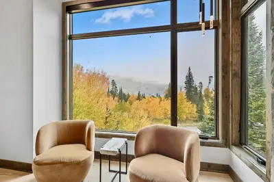 two chairs sitting in front of a large window at Brand New Eagles Nest Property in Silverthorne