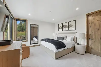 a white bedroom with a bed and a window at Brand New Eagles Nest Property in Silverthorne