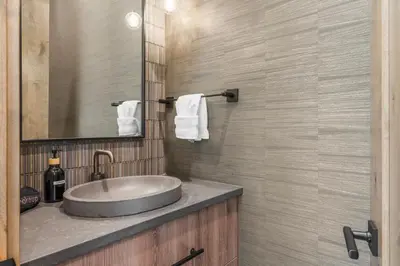a bathroom with a sink and a mirror at Brand New Eagles Nest Property in Silverthorne