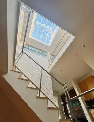 a staircase in a house with a skylight at Luxe 4 bed 5 bath with Parking Walk to Capitol, Convention Center, museums and shops in Denver