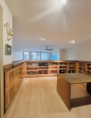a large kitchen with wooden cabinets and a table at Luxe 4 bed 5 bath with Parking Walk to Capitol, Convention Center, museums and shops in Denver