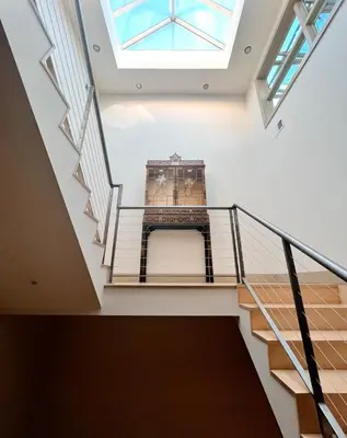 a staircase in a building with a skylight at Luxe 4 bed 5 bath with Parking Walk to Capitol, Convention Center, museums and shops in Denver
