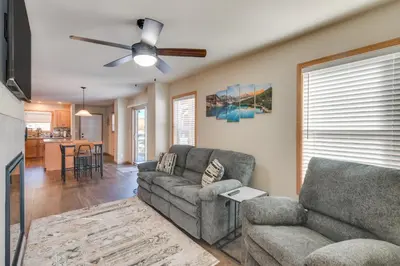 a living room with a couch and a ceiling fan at 4 Mi to Granby Ranch Cabin with Hot Tub Access! in Granby