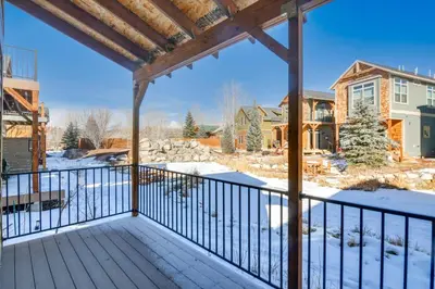 a porch with snow on the ground and houses at 4 Mi to Granby Ranch Cabin with Hot Tub Access! in Granby