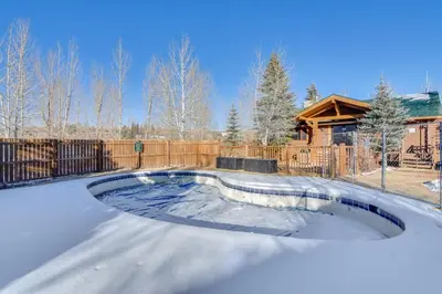 a swimming pool in a yard with a house at 4 Mi to Granby Ranch Cabin with Hot Tub Access! in Granby