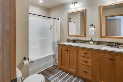 a bathroom with two sinks and a shower at 4 Mi to Granby Ranch Cabin with Hot Tub Access! in Granby