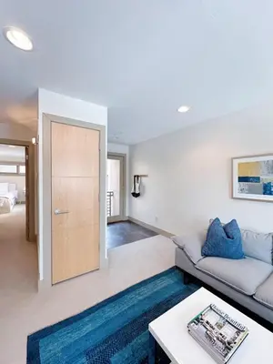 a living room with a couch and a table at 1 bed apartment with parking - Denver Museum District Walk to Convention Center, Capital, museums and shops in Denver