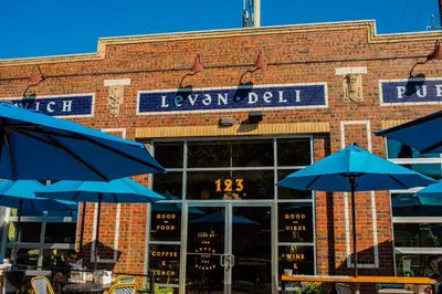 a brick building with blue umbrellas in front of it at 1 bed apartment with parking - Denver Museum District Walk to Convention Center, Capital, museums and shops in Denver