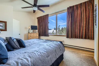 a bedroom with a bed and a large window at 2017 Lodgepole condo in Keystone