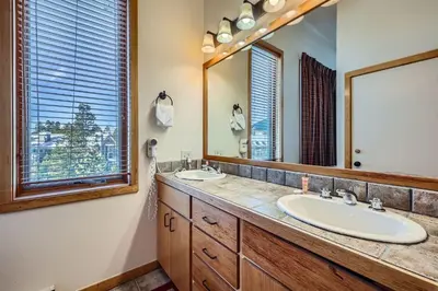 a bathroom with two sinks and a large mirror at 2017 Lodgepole condo in Keystone