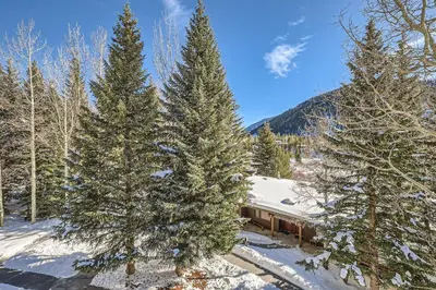 an aerial view of a house in the snow with trees at 2017 Lodgepole condo in Keystone