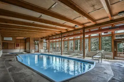 a large swimming pool in a building with windows at 2017 Lodgepole condo in Keystone