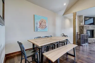 a dining room with a table and chairs and a fireplace at Luxury Home - Sleeps 10 - Fireplace & Mountain View condo in Keystone