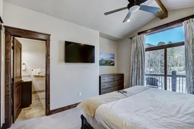 a bedroom with a bed and a large window at Luxury Home - Sleeps 10 - Fireplace & Mountain View condo in Keystone