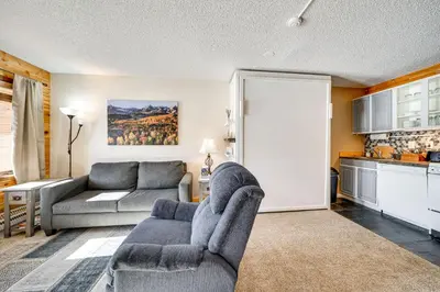a living room with a couch and a table at 2 Mi to Granby Ranch Mtn-View Studio with Perks in Granby