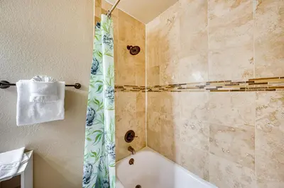 a bathroom with a tub and a shower curtain at 2 Mi to Granby Ranch Mtn-View Studio with Perks in Granby
