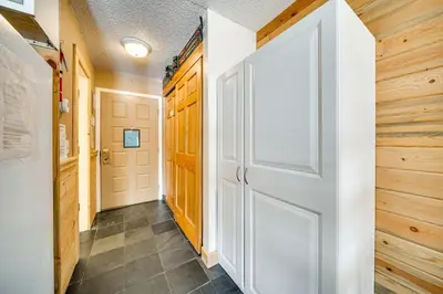 a hallway with a white door and wooden walls at 2 Mi to Granby Ranch Mtn-View Studio with Perks in Granby