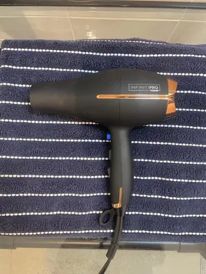 a hair dryer sitting on top of a pile of towels at RiNo Self-Care Studio in Denver