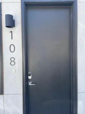 a black door to a building with the number at RiNo Self-Care Studio in Denver