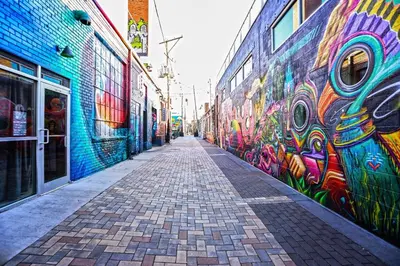 a street with graffiti on the side of a building at RiNo Self-Care Studio in Denver
